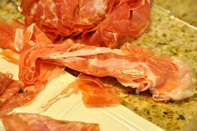 prosciutto wrapped around asparagus: Prosciutto laying on counter