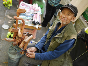 man selling wood canes in Guiyang