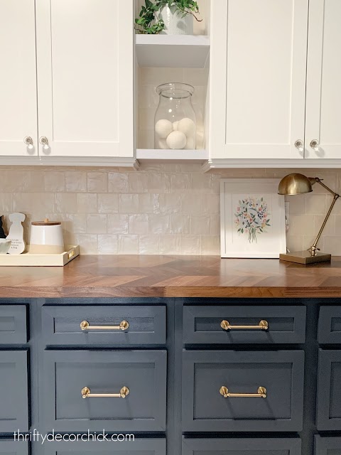 Laundry room counter with cream tile blue cabinets