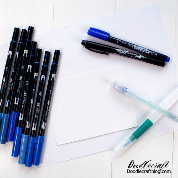 Supplies needed for blue galaxy watercolor cards: Tombow Dual Brush Pens, Glue Pen, Waterbrush and watercolor paper.