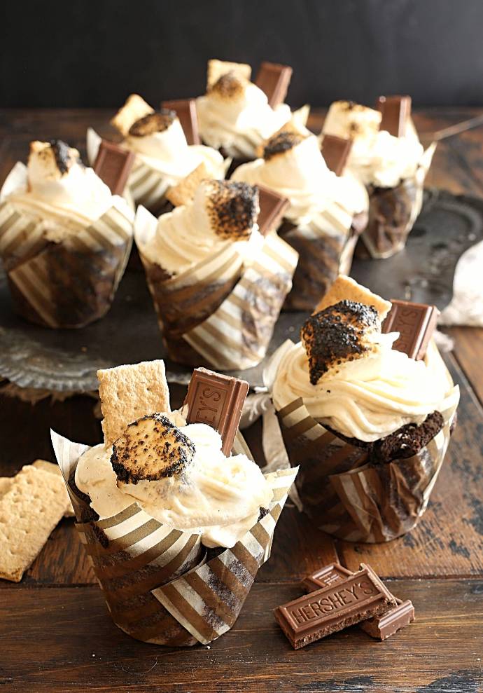 Smores-Cupcakes-1 Recipe for a chocolate cupcake with a graham cracker crust base, topped with marshmallow butter frosting.