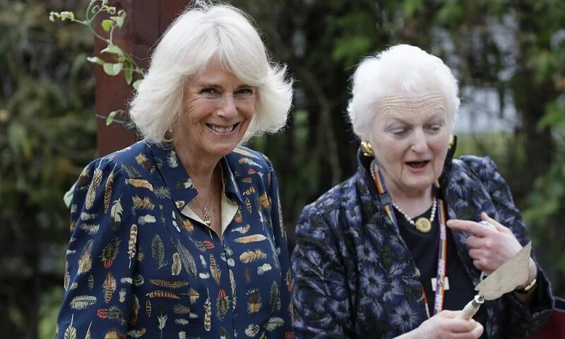 The Duchess of Cornwall wore a navy blue shirt dress with feather print detail