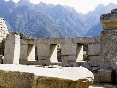 Iconic Machu Picchu Images: Sun rays coming through the trapezoidal windows at Machu Picchu