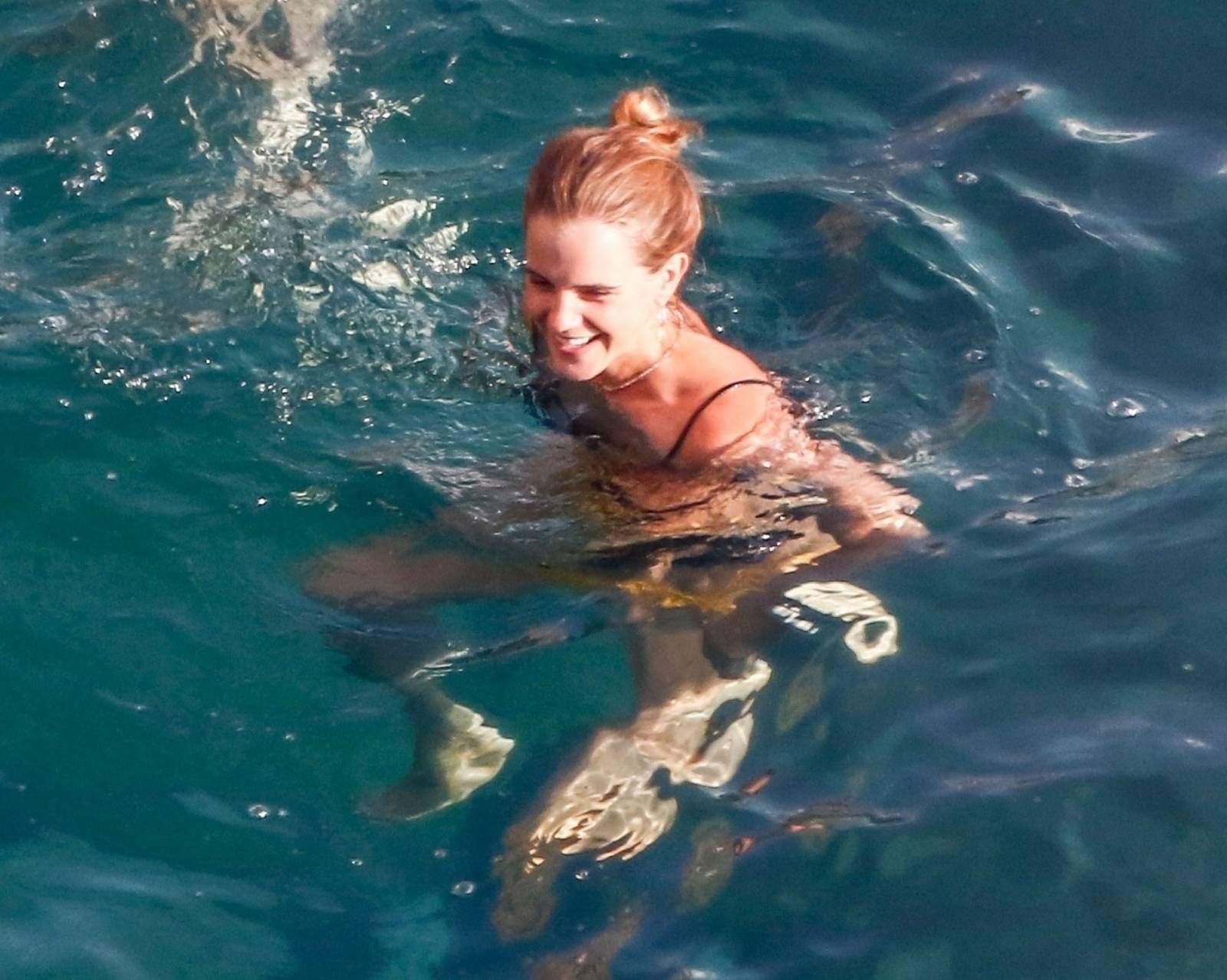 EMMA WATSON rocking a yellow bikini in Positano, Italy.