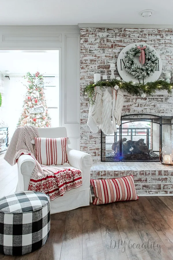 rustic fireplace with neutral decorated Christmas mantle