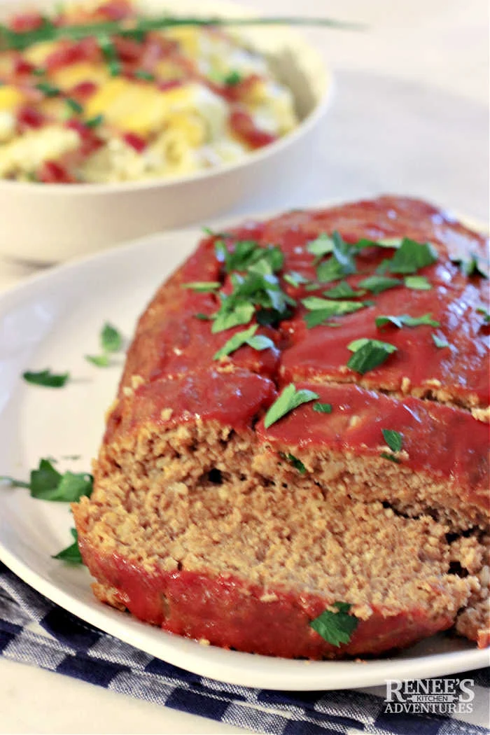 Lipton Onion Soup Meatloaf sliced with potato side dish in the background