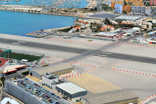 Close-up view showing cars crossing the runway at the Gibratar airport.