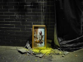 Piece of art in a broken frame in a Zhongshan alley