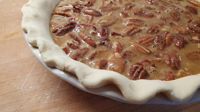 maple bourbon pecan pie ready to be baked