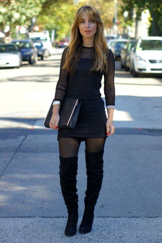 Woman wearing black mini dress, black tights and black boots