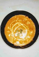 Garnished  Paneer makhani with cream after cooking in a pan