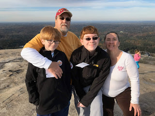 A photo of David Brodosi and his family on top of the mountain