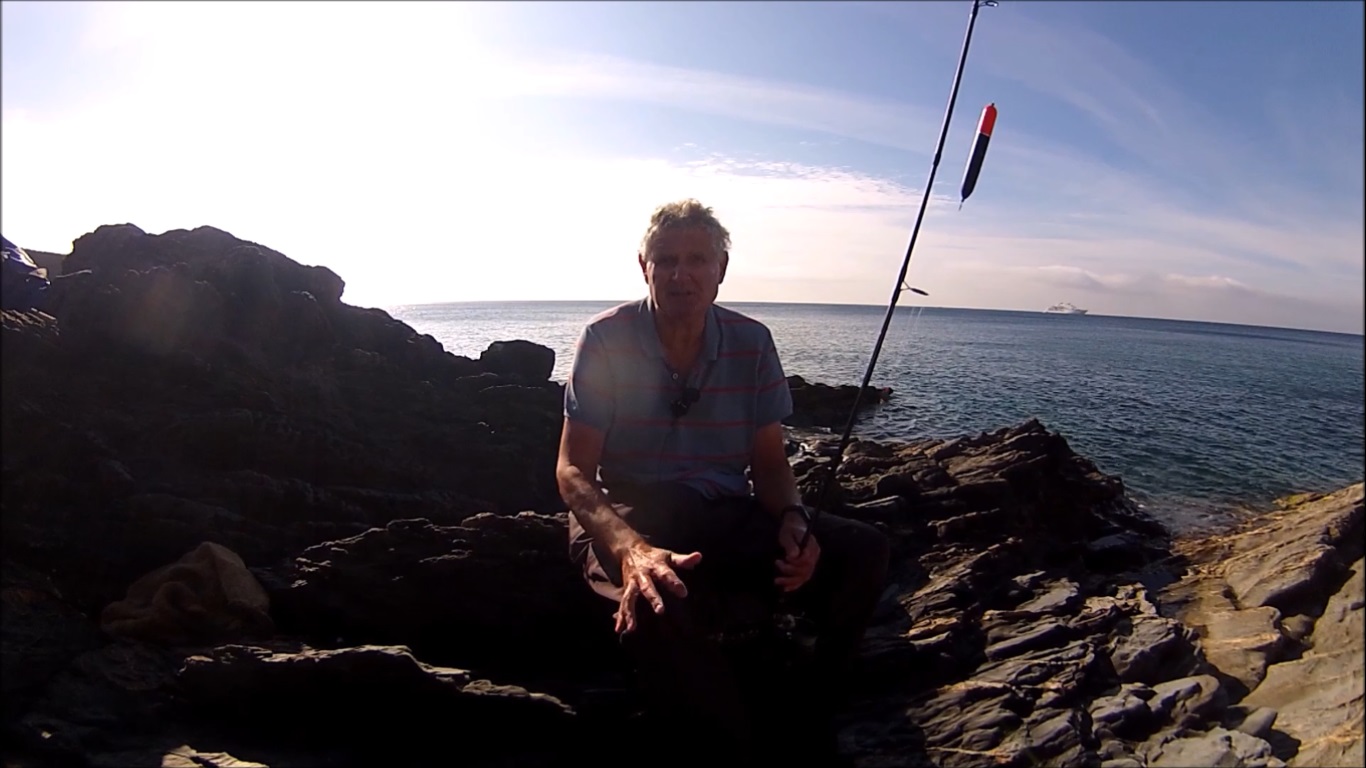 Cornish Shore and Kayak Fisherman Summer Float Fishing for Mackerel