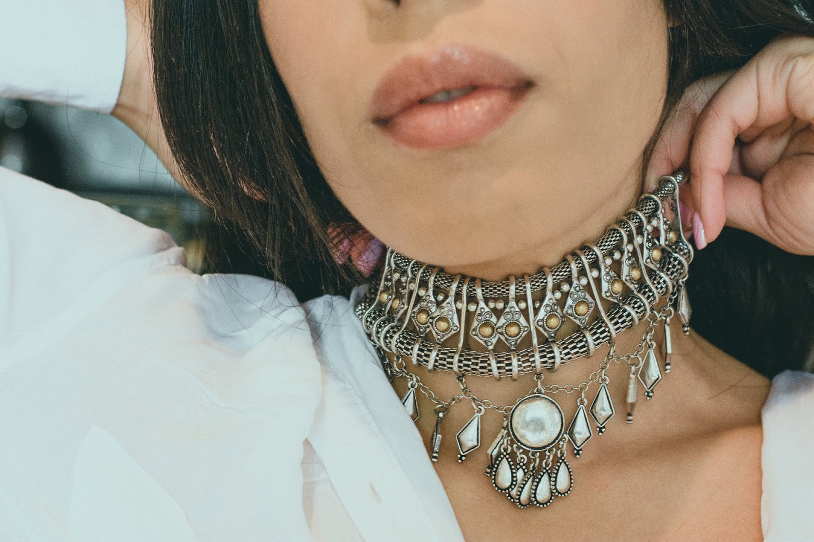 woman is wearing beautiful statement necklace on her neck