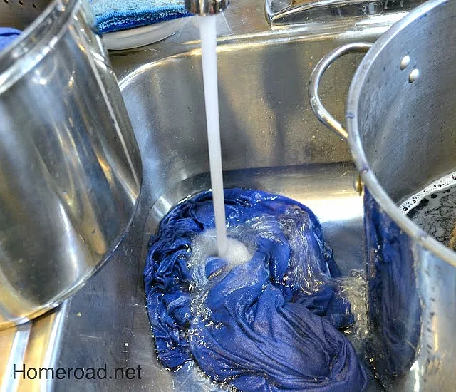 rinsing blue t shirt in the sink
