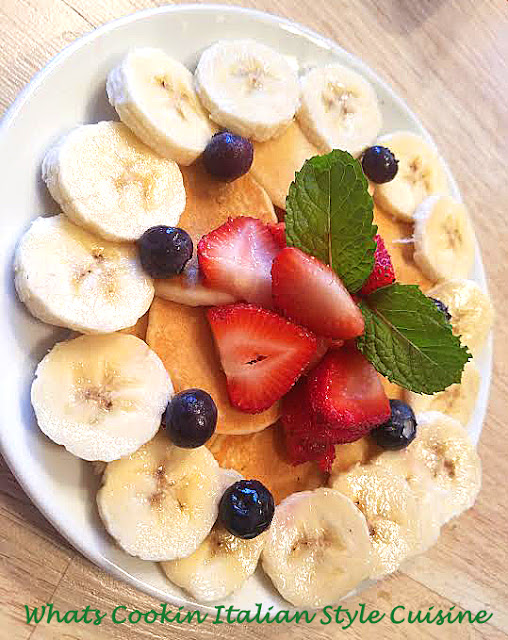 these are homemade pancakes with bananas, strawberries and blueberries for 4th of july breakfast