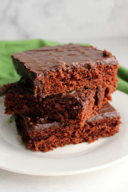 Texas sheet cake is the perfect dessert for a get together. It comes together so quick and easily and is perfect for a crowd. Make one for your next party and everyone is sure to be happy! stack of 3 slices of chocolate cake