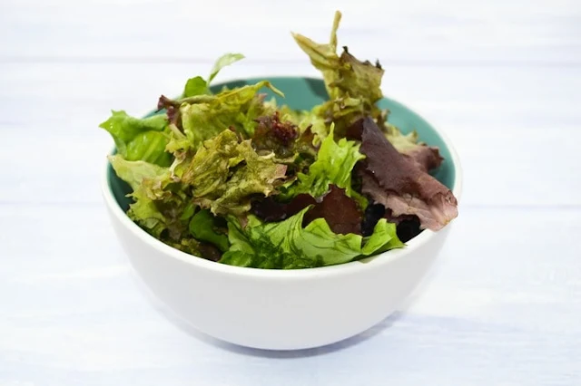 white bowl full of mixed salad leaves