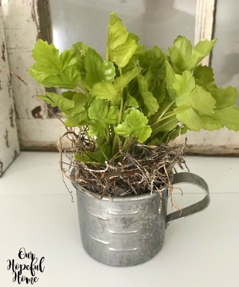 ti measuring cup filled with faux greenery