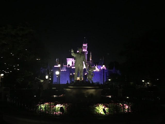 Partners Statue In Front Of Sleeping Beauty Castle At Night Disneyland