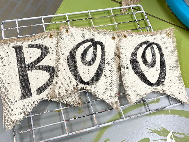 Burlap flags stenciled with BOO in black