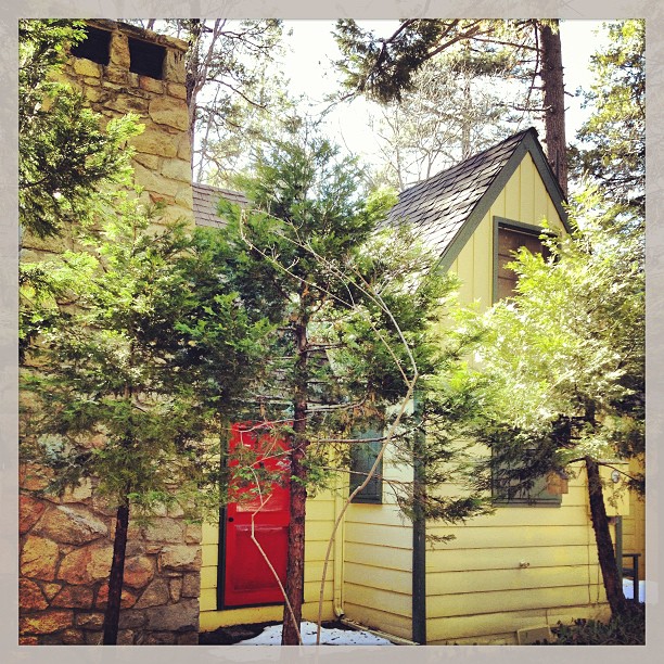 yellow house with green trim and red door