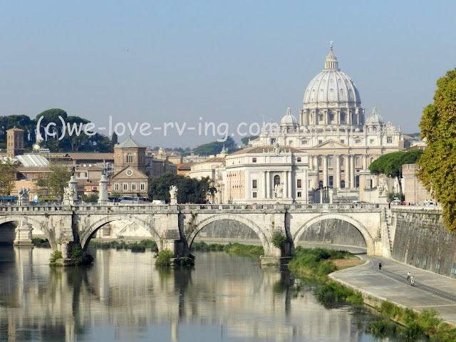 We look down the Tiber River to see St. Peter's Basilica