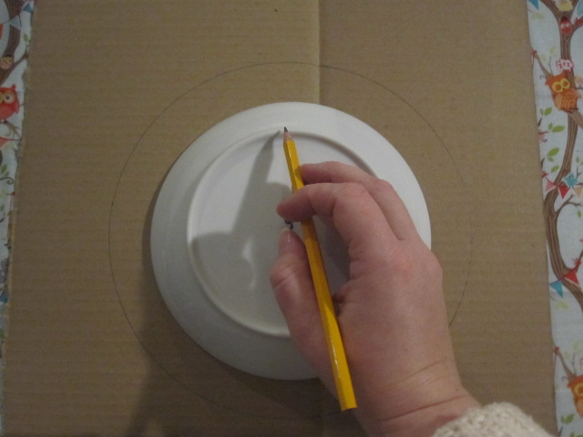 Plate being drawn around on a piece of card