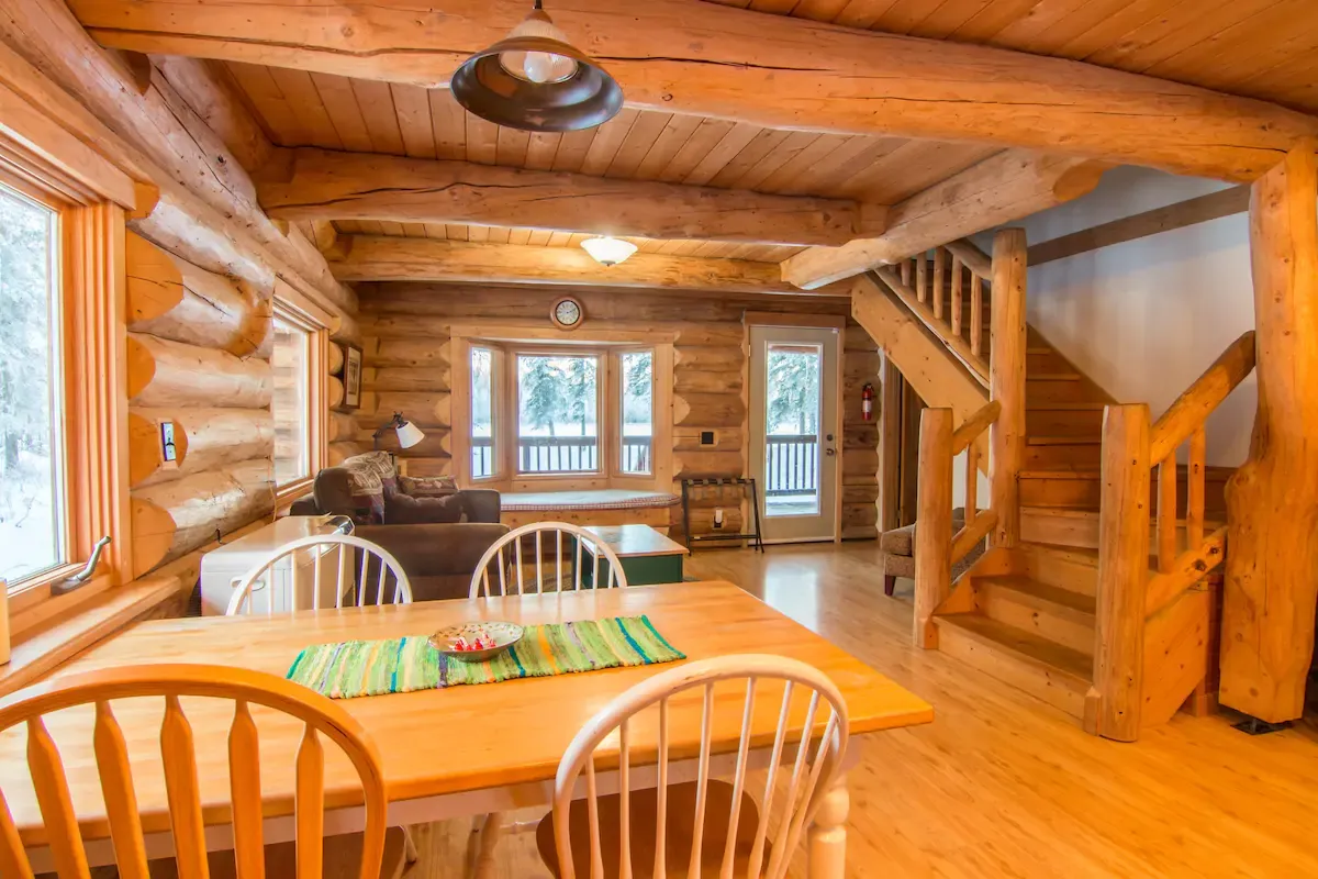 cozy-log-cabin-is-available-for-rent-on-airbnb-with-dining-area-and-living-room
