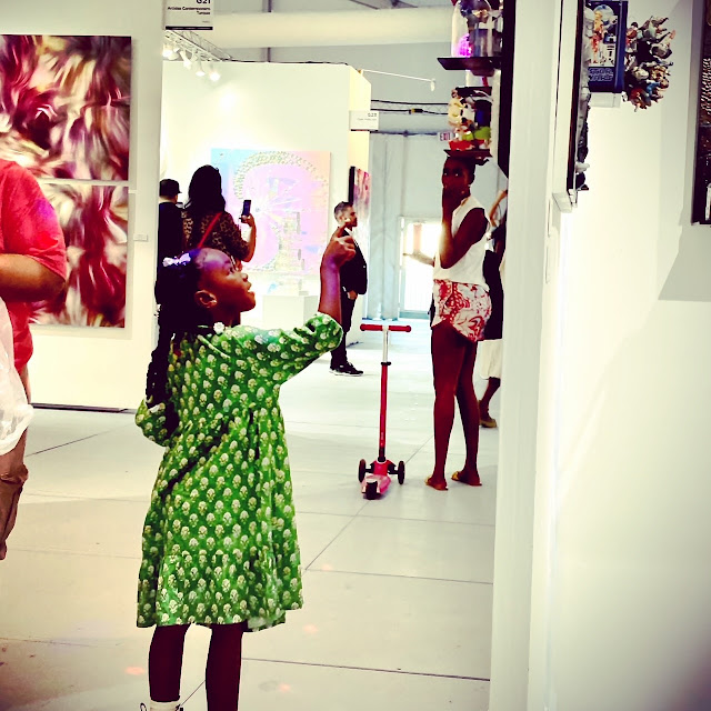 Young art fan admiring a Janis & Porto at SCOPE Art Fair Miami Beach 2021