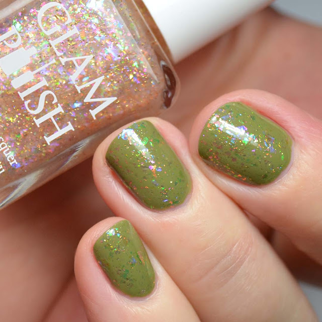 rainbow flakie nail polish over green swatch