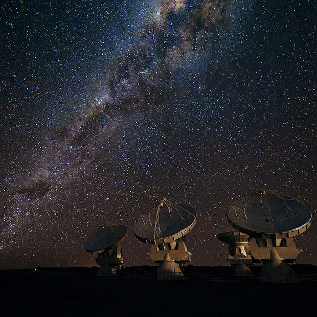 Four ALMA antennas on Chajnantor under the Milky Way