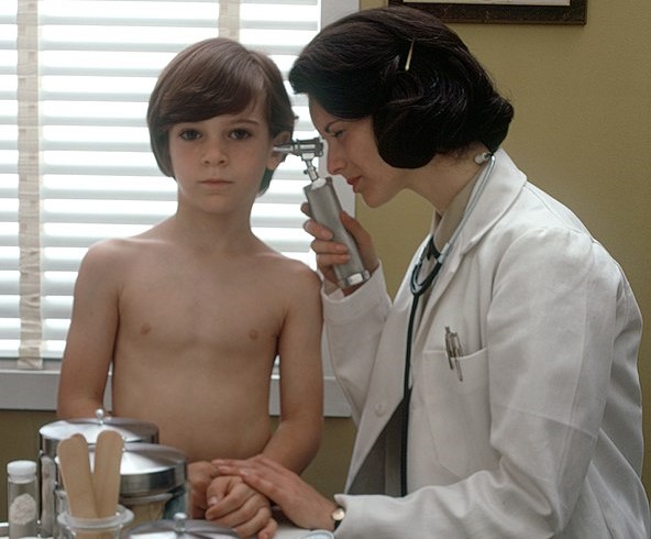 A female doctor examines a child