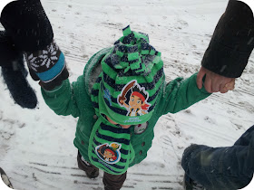 walking in the snow with a toddler, jake and neverland pirates hat