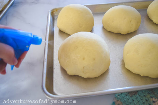 spraying bread bowl dough with water