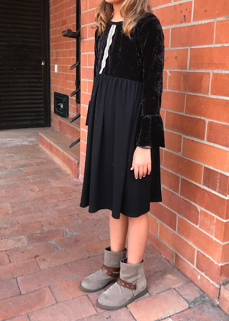 Girls' DIY black velvet bell sleeve dress from a free pattern.