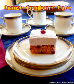 Orange Cranberry Cake features favorite seasonal flavors. This cranberry studded orange cake is frosted with cranberry whipped cream. |  Recipe developed by www.BakingInATornado.com | #recipe #cake