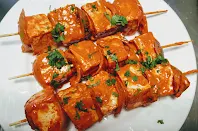 Three wooden stick with paneer for paneer Tikka