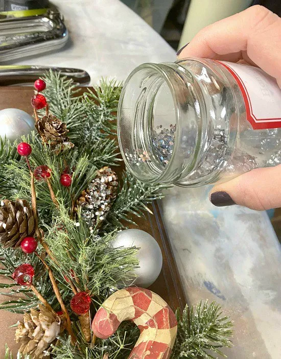 Christmas greenery and glitter on a cabinet door