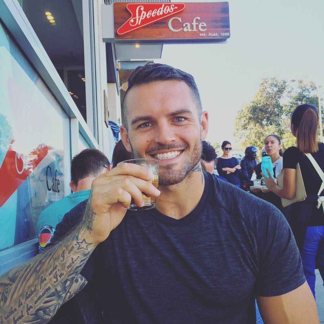 handsome-blue-eyed-daddy-smiling-drinking-cafe-arm-tattoo