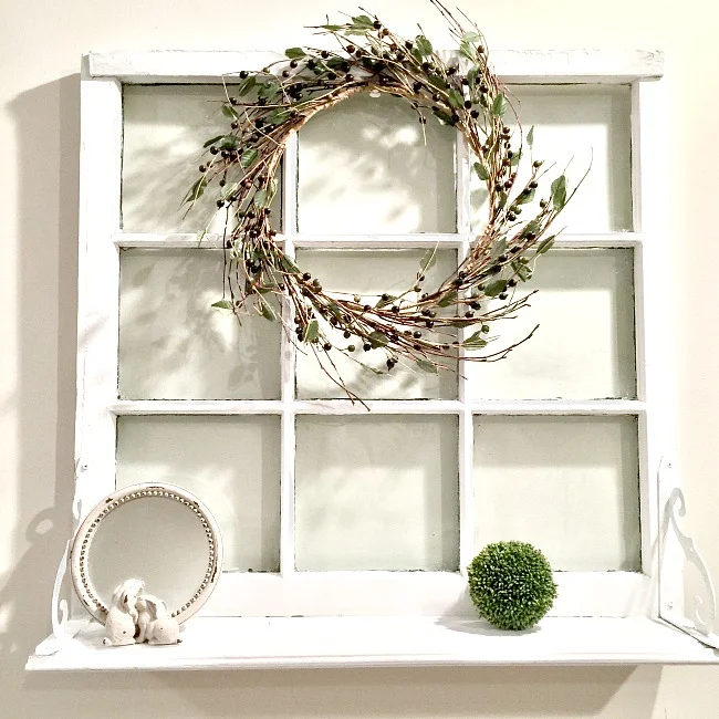 Old window turned into a decorative shelf