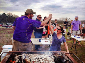 Jay Ducote and Aimee Tortorich congratulate each other on mastering the Cajun Microwave whole hog cookery.