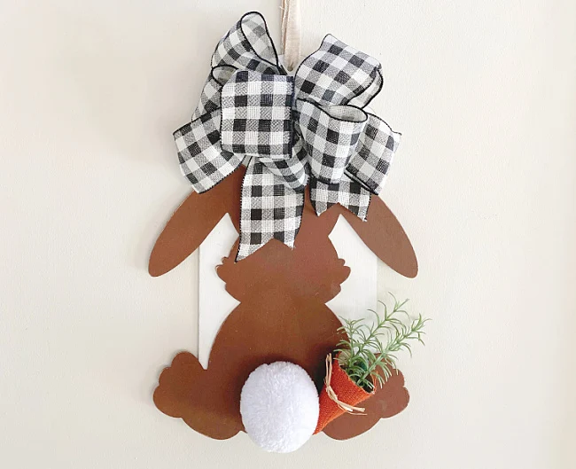 Brown bunny with buffalo checked bow, a bunny tail and a carrot