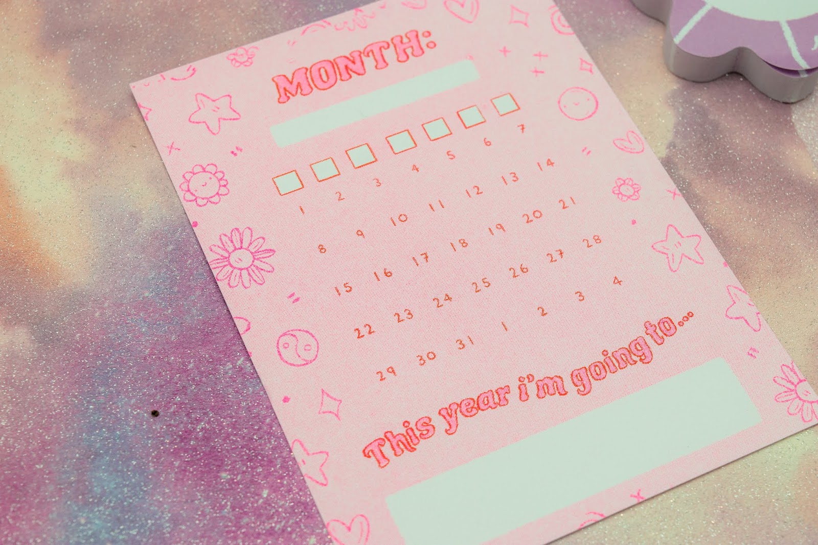 What Cat Says | Papergang Unboxing - December 2019 A close up of a monthly calendar post card. It is pink with neon pink outline.