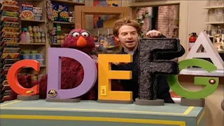 Telly and deliveryman Vinny (Seth Green) glances at the letters. Telly joins the Letter of the Month Club. Sesame Street Preschool is Cool ABCs With Elmo