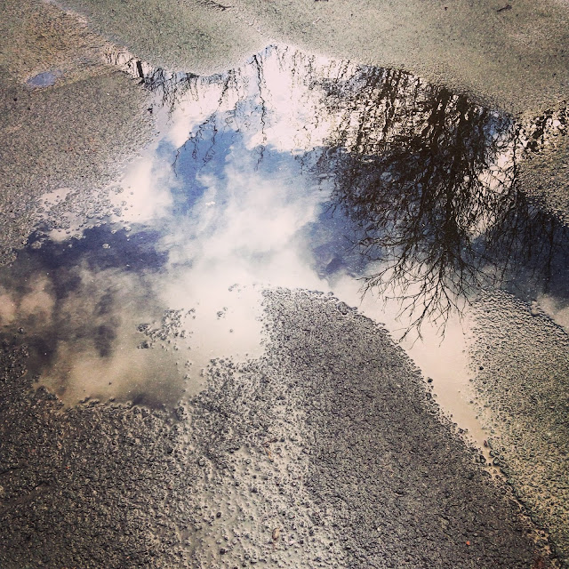 Sky reflection in a puddle