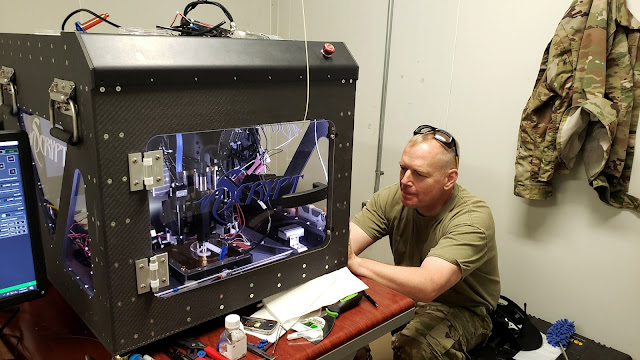 A man works with a 3D printer