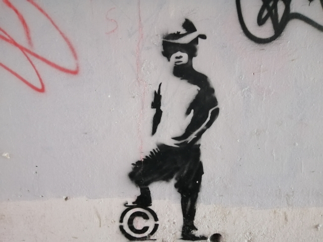 Banksy_style_Copyright_Boy_Stencil_Graffiti