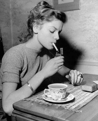 Lauren Bacall taking a smoke-and-coffee break