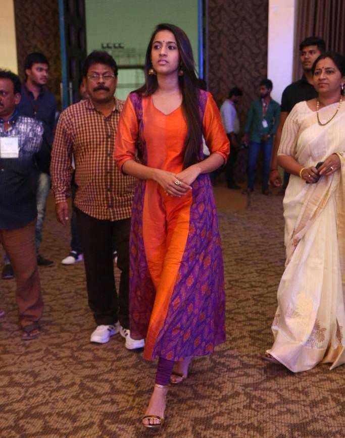 Niharika Stills In Orange Dress At Telugu Movie Pre Release Function